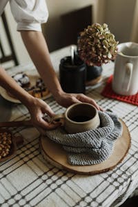Clear crochet patterns sell better. Warm breakfast table with a ceramic mug and cozy decor, inviting a rustic home atmosphere.